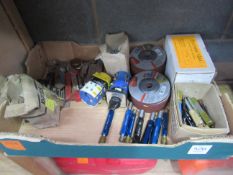 A box of various machine tooling and Makita grinding disks