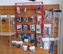 Assortment of motorbike sundries, to wall rack, to include bar sliders, frame sliders, clips, bolts,