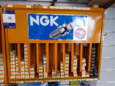 NGK metal wall mountable rack and contents, to include various spark plugs