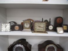 Shelf of small mantle clocks, carriage clock etc