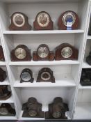 Four shelves of wooden mantle clocks (varying states of completion)