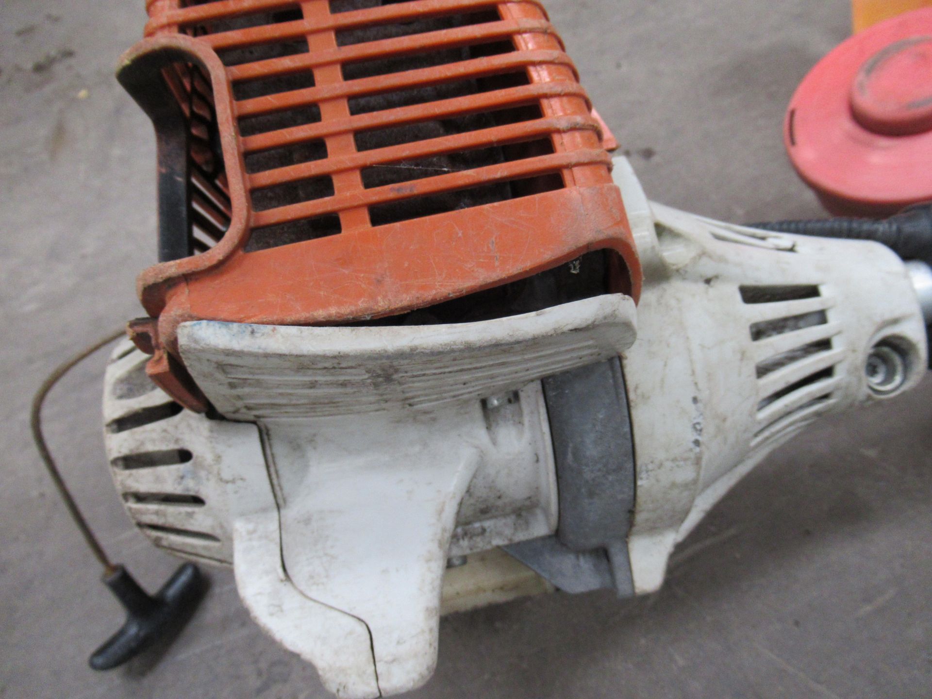 A Stihl multi-tool engine with a Mitox chainsaw head and an unbranded strimmer head (spares/repairs) - Image 5 of 7