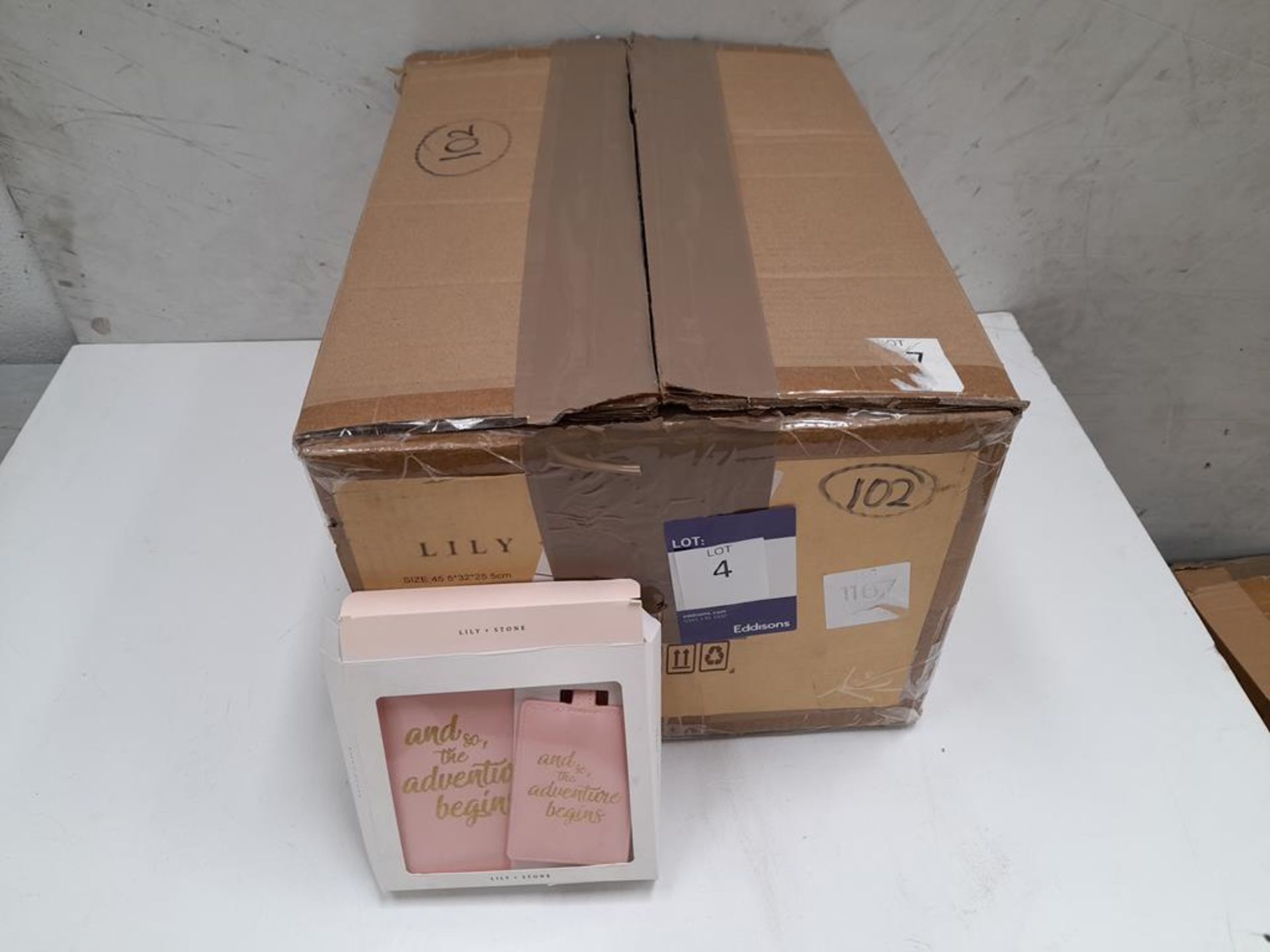 A box of Lily and Stone 'Passport holder and tag s