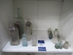 Shelf of Inkwells - including cottage inkwell and Boots chemist bottles.