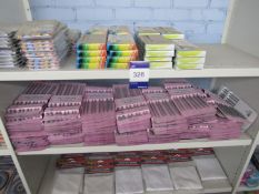Contents of bay of shelving to include knitting needle sets, line free cloths, acrylic paints and