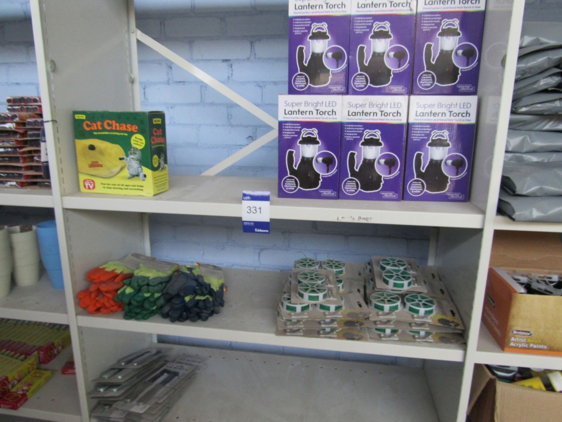 Contents of bay of shelving to include 9 x superbright LED lantern torches, work gloves, garden wire