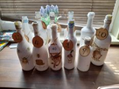 Quantity of various decorative table marking bottles