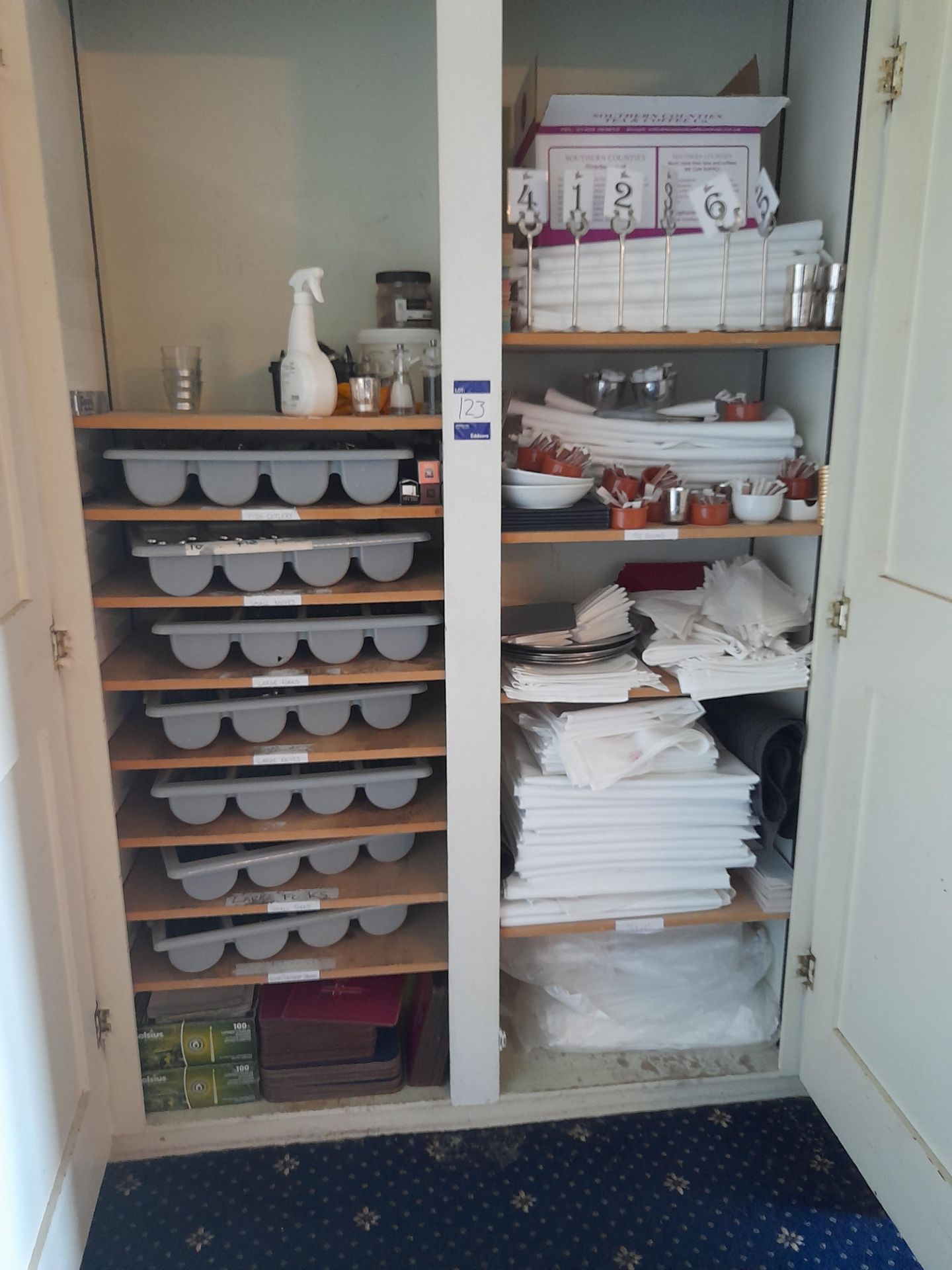 Large qty of cutlery & table linen to cupboard