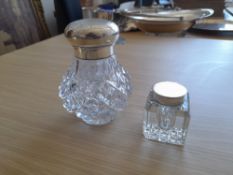 Two cut glass inkwells with hallmarked silver mounts