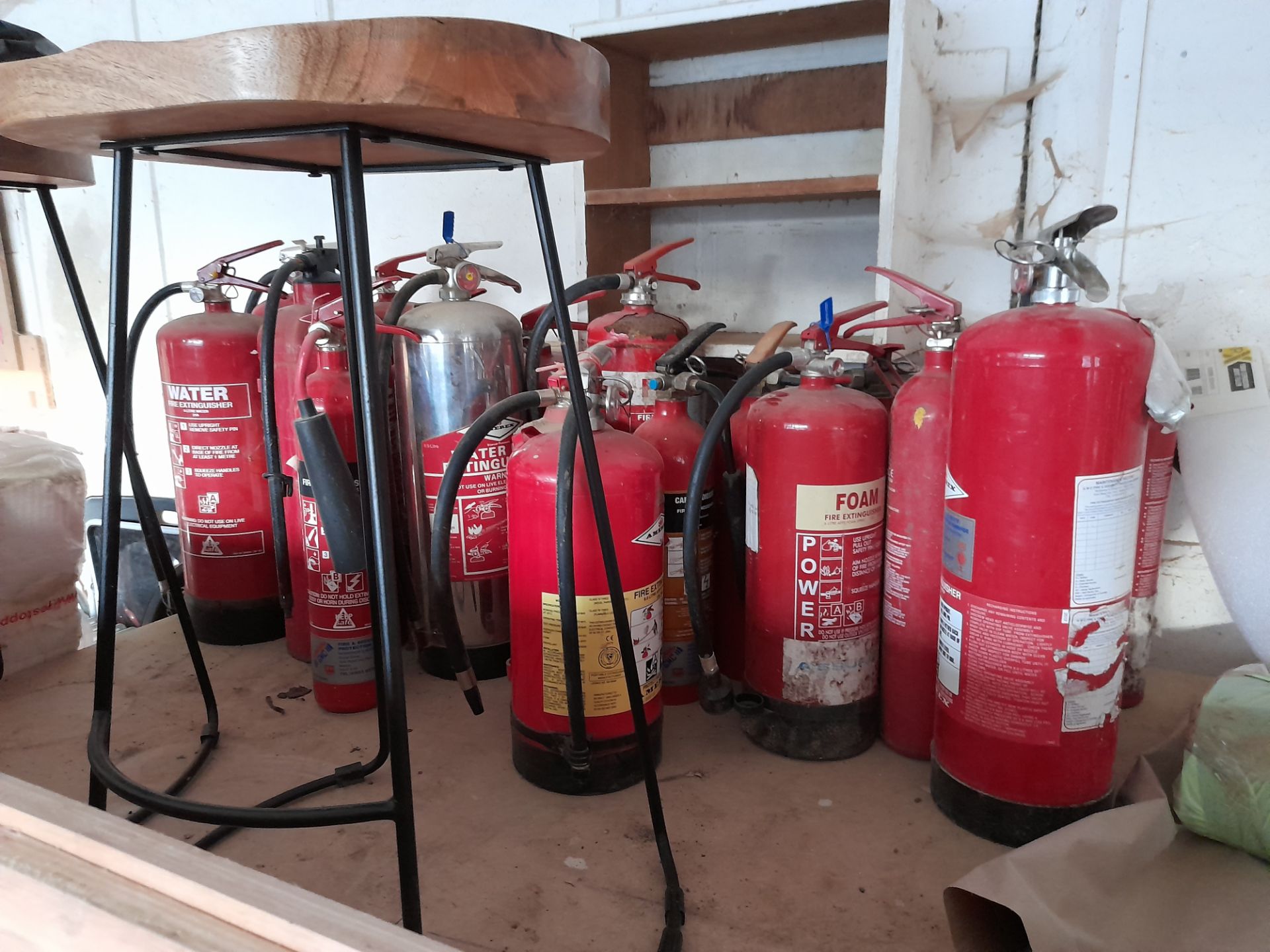 Qty of various fire extinguishers with site safety stand.