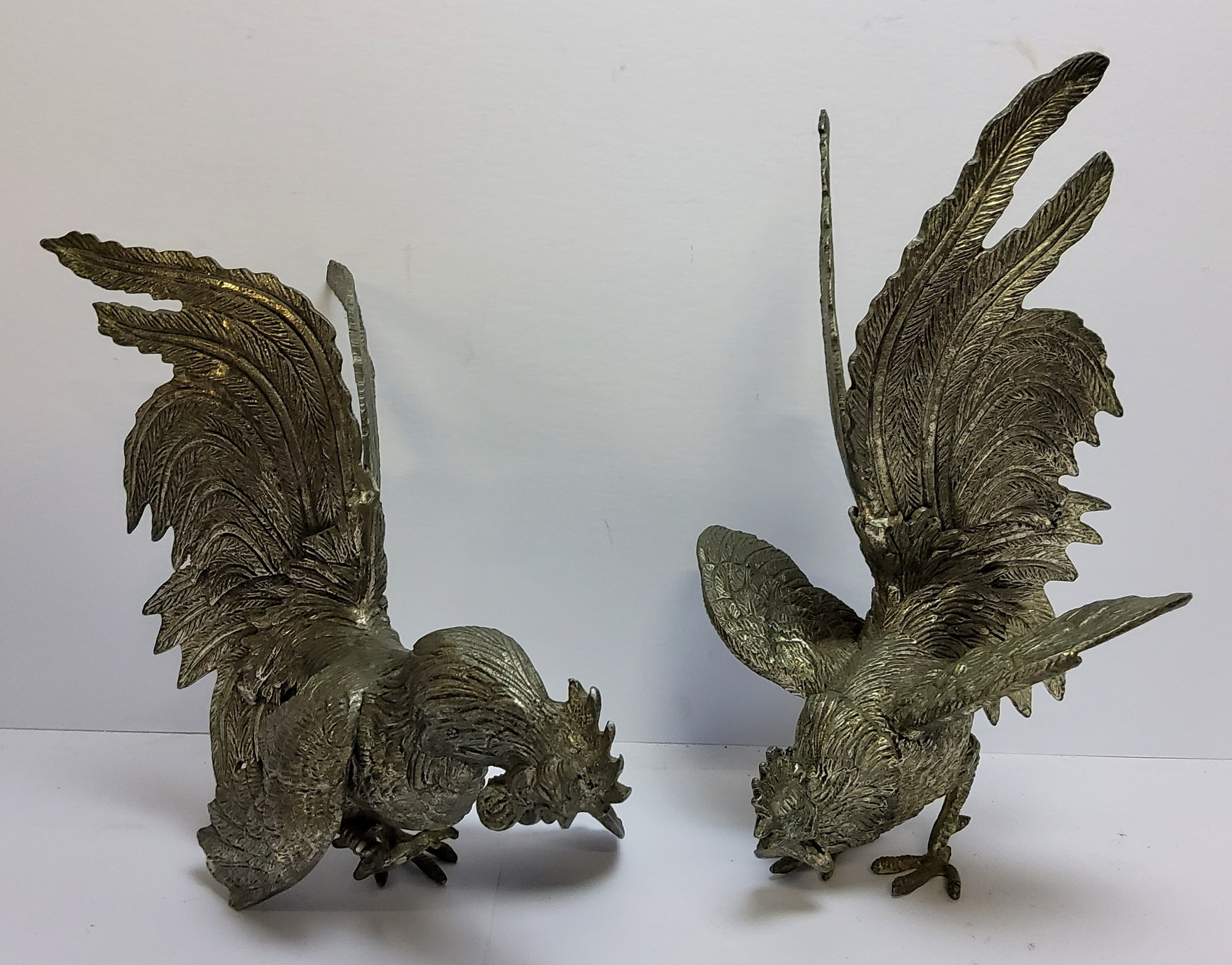 A pair of early 20th century pewter cock fighting models, 15cm high