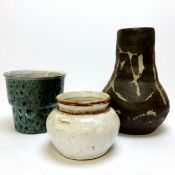 Three pieces of studio pottery including a coiled and raku fired rust glazed example, another