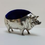 A large white metal Adie & Lovekin type pin cushion in the form of a pig, 11cm wide.