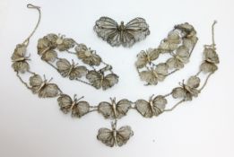 An early 20th century Indian white metal filigree butterfly jewellery set with conforming