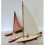 A scratch built pond yacht, red hull, stand; another catamaran (2)