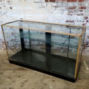 An early 20th century shop display counter, adjustable metal shelf interior 154 wide x 91high x 56.