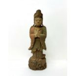 A Chinese deity, 18th century style, carved out of wood painted in polychrome, scrolling cloud base,