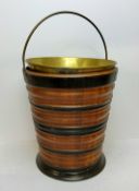 A Dutch walnut and ebonised kettle bucket, decorated with turned banded construction, with a brass