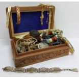 A carved Indian jewellery box, full of costume jewellery including Whitby jet mourning brooch,