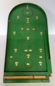 A Chad Valley bagatelle board with the original scoreboard and steel balls