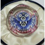 A Whitefriars millefiori glass paper weight the centre decorated with a house and two angels,