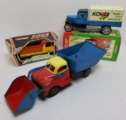 A West German Gama tipper truck with front loader bucket, red cab, cream roof, blue bucket and