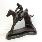 Horse Racing Interest - A well executed bronze horse and jockey clearing a fence, veined belge