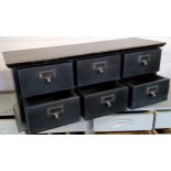 A bank of six haberdashery drawers, painted black, 20th century, 71cm wide x 27.5cm high x 23.5cm