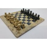 A highly polished fossilised coral and black marble chess set