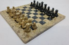 A highly polished fossilised coral and black marble chess set