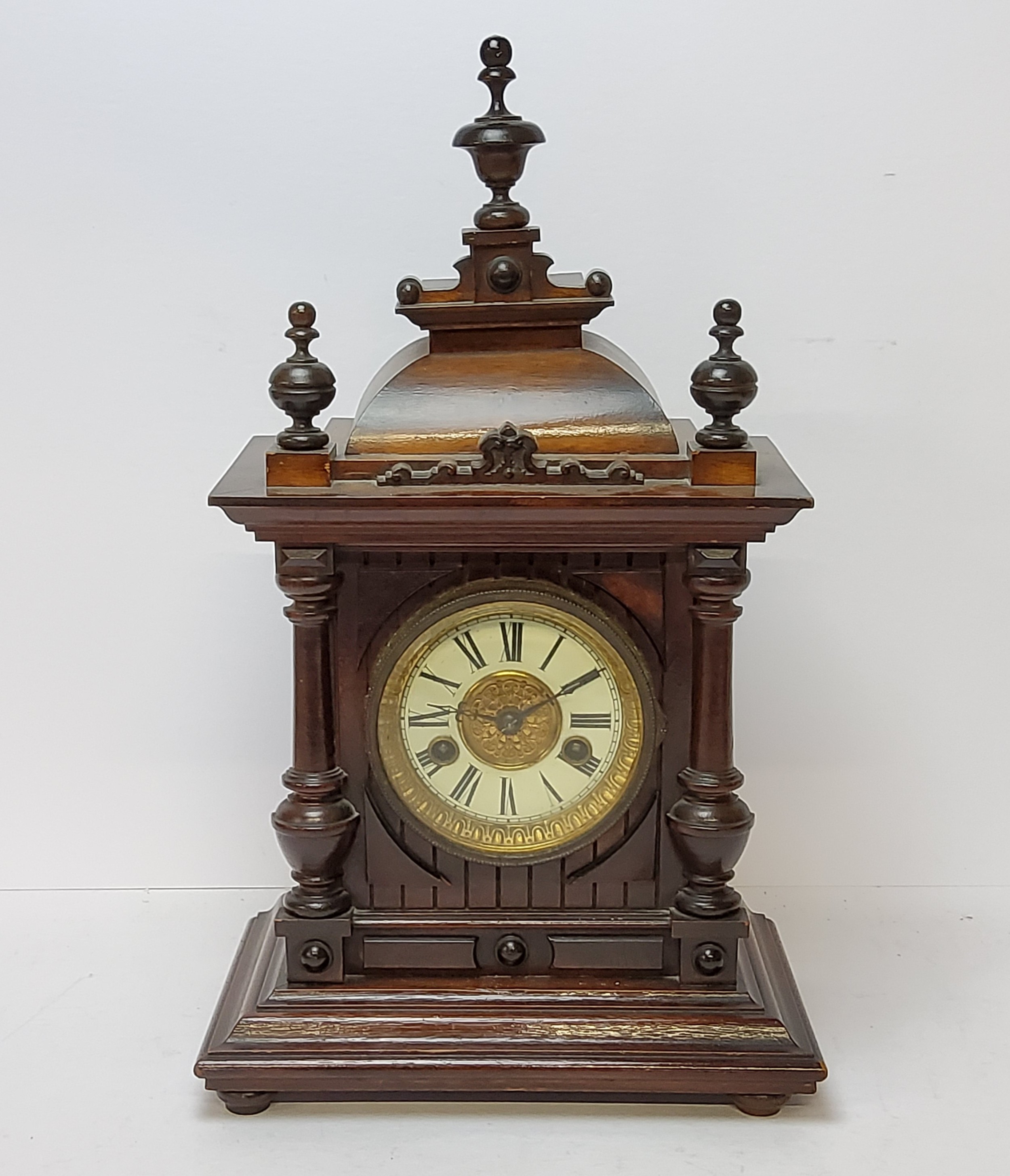 A walnut cased H.A.C. 14 day strike mantel clock, striking on a coiled gong. bevelled glass