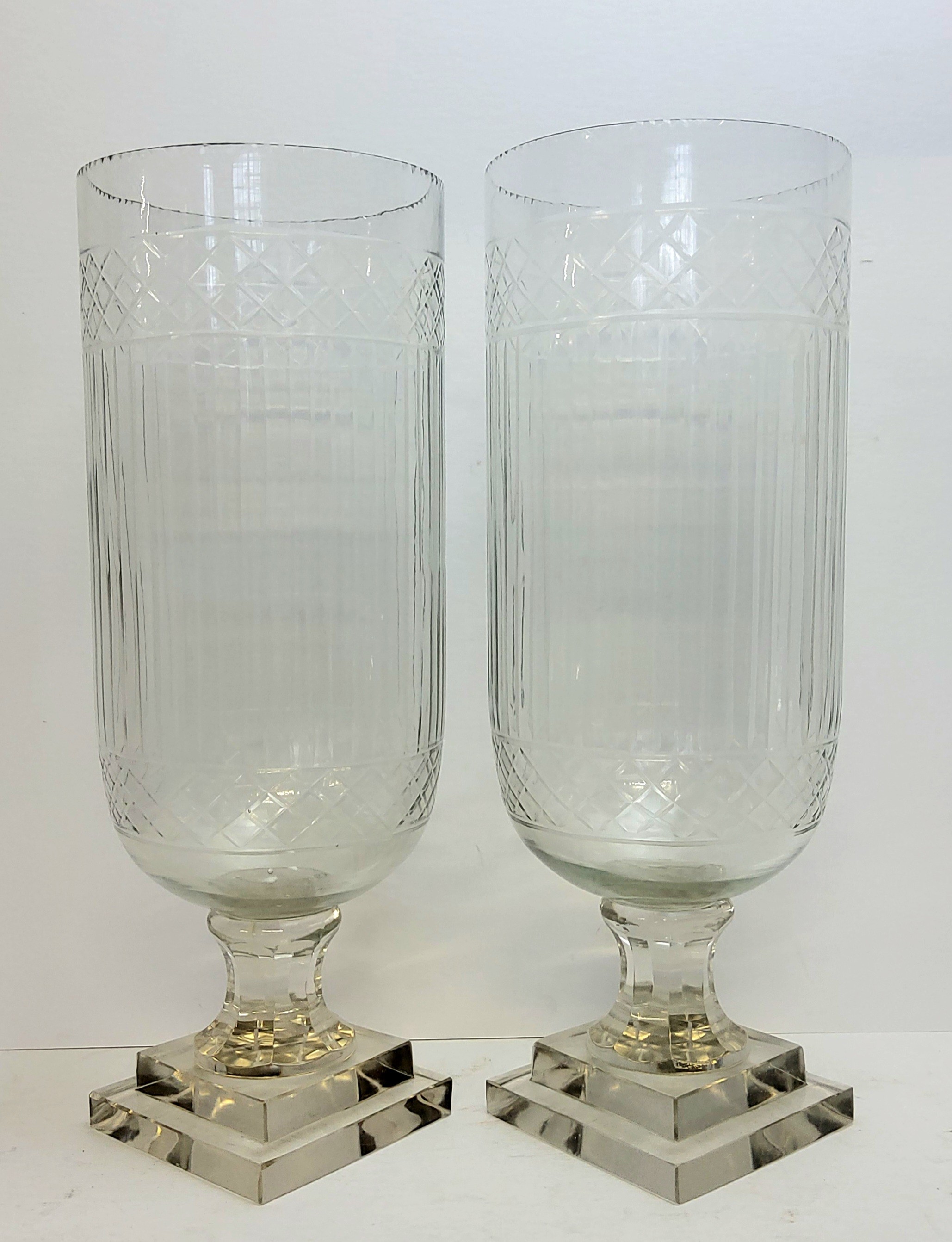 A pair of substantial cut glass storm lanterns, heavy stepped square base, 41cm / 17".