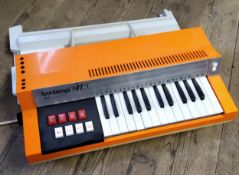 A retro Bontempi Hit 258 electric organ, orange/cream, complete with legs c.1970's