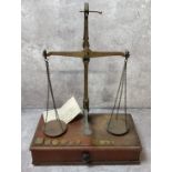 A pair of Victorian apothecary scales, apothecary weights with an F Woodhead, Sheffield artificial