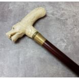 A 19th century Chinese novelty walking stick pommel, carved bone in the form of a dogs head with
