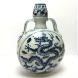 A Chinese Ming style blue and white moon flask, decorated with imperial dragon amongst the clouds,