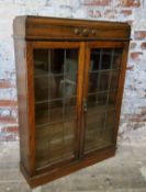 A 1930's English oak freestanding bookcase, Art Deco moulded frieze, enclosing adjustable shelves,