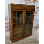 A 1930's English oak freestanding bookcase, Art Deco moulded frieze, enclosing adjustable shelves,