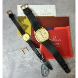 An Omega gentleman's & lady's matching gold plated wristwatches, quartz movement, gold dial, black