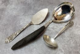 A large Burmese white metal serving spoon with carved ebony handle; A 20th century 800. grade silver