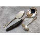 A large Burmese white metal serving spoon with carved ebony handle; A 20th century 800. grade silver