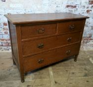 An early 20th century oak chest of two short above two long drawers, pressed Art Nouveau