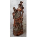 A large Chinese hardwood carving of the immortal Shoulao with a boy, well carved and pierced