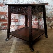 An English oak hall table, profusely carved with floral borders and scale detailed outspleighed