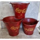 Advertisement- a set of three graduated Coca Cola buckets