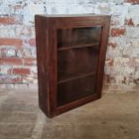 An early 20th century stained pine display cabinet, glass door in good order housing three