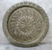 A substantial Indian Kutch charger profusely decorated in relief with stylised fish and flora