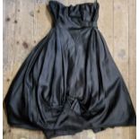 A Frank Usher black silk cocktail dress. hooped under skirt, boned bodice, bow details to skirt