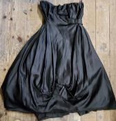 A Frank Usher black silk cocktail dress. hooped under skirt, boned bodice, bow details to skirt
