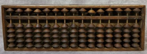 An early 20th century Chinese padouk wood abacus 33cm wide